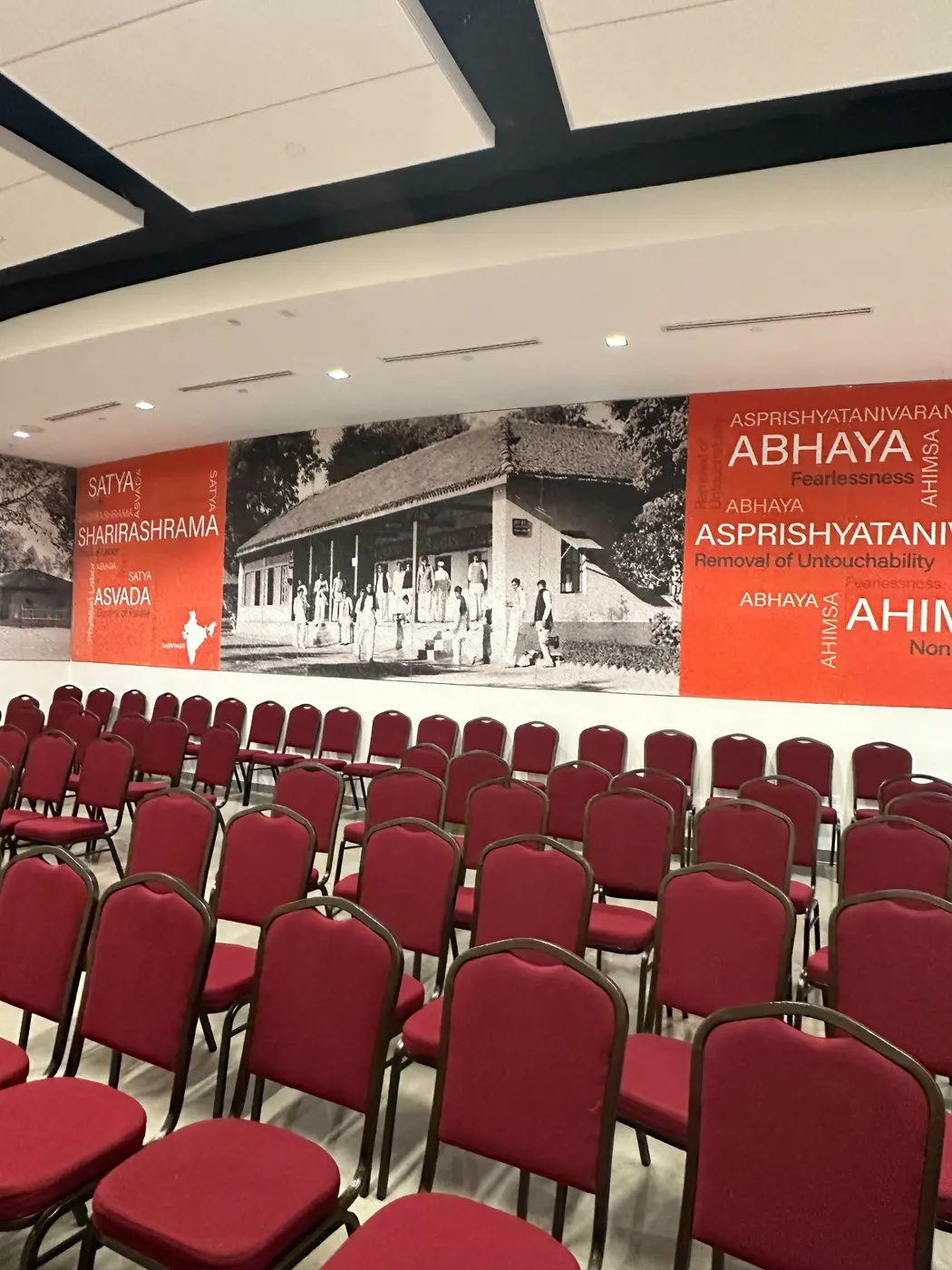 Wide auditorium view toward the Gandhi mural