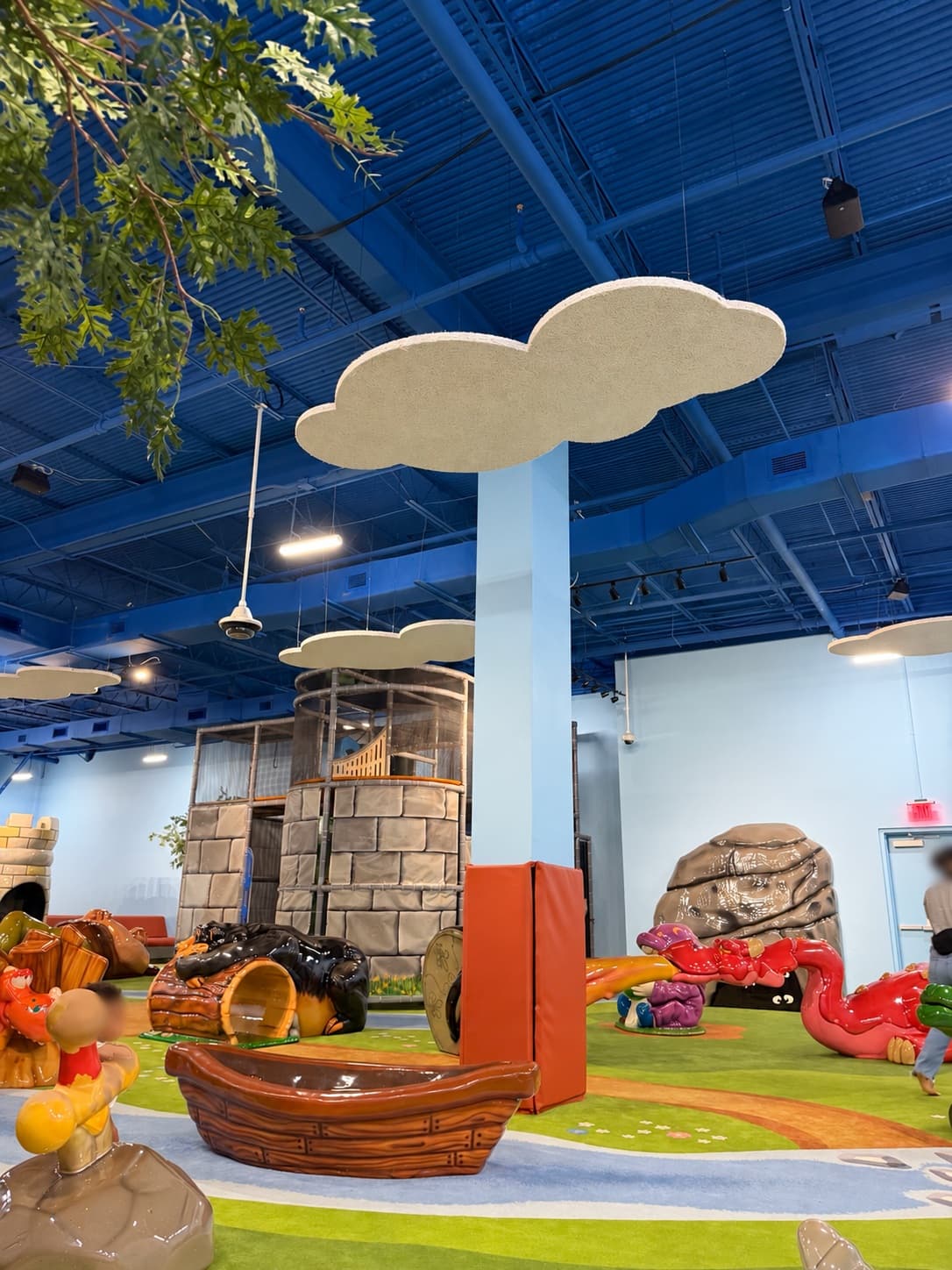 Cloud-shaped Tectum® panels above the castle tower, boat, and storybook figures