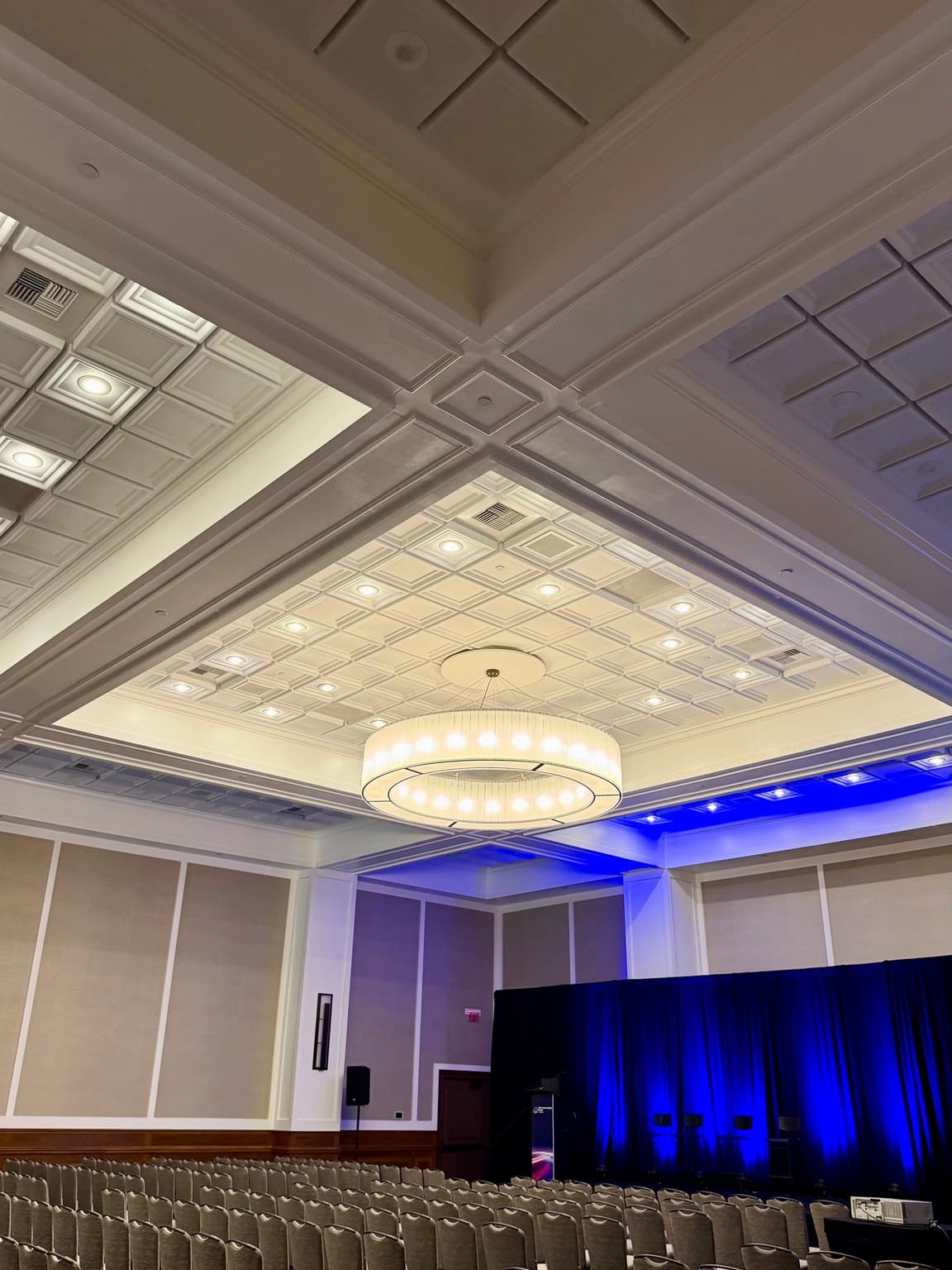 Qwel recessed ceiling tile and chandelier above the Yellow Rose Ballroom